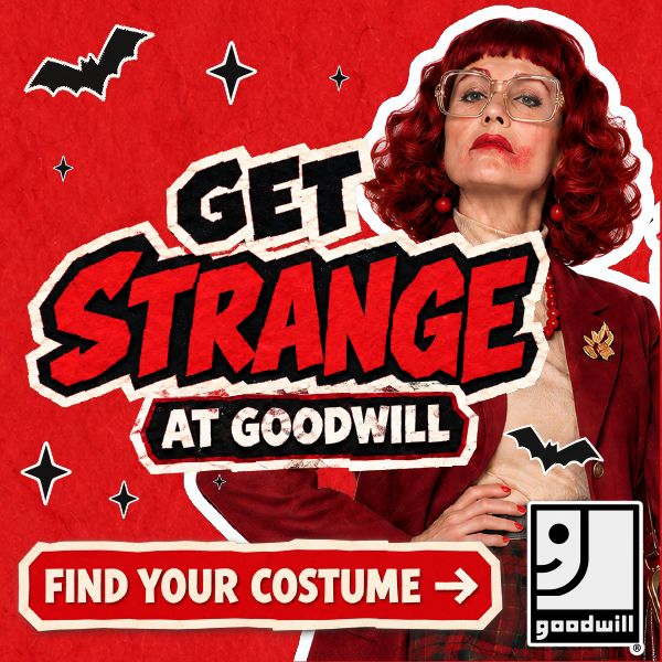 Get Strange at Goodwill, red-haired woman in glasses and a maroon blazer on red.